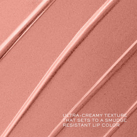 Lancôme lipstick beside coin showing compact size and travel convenience