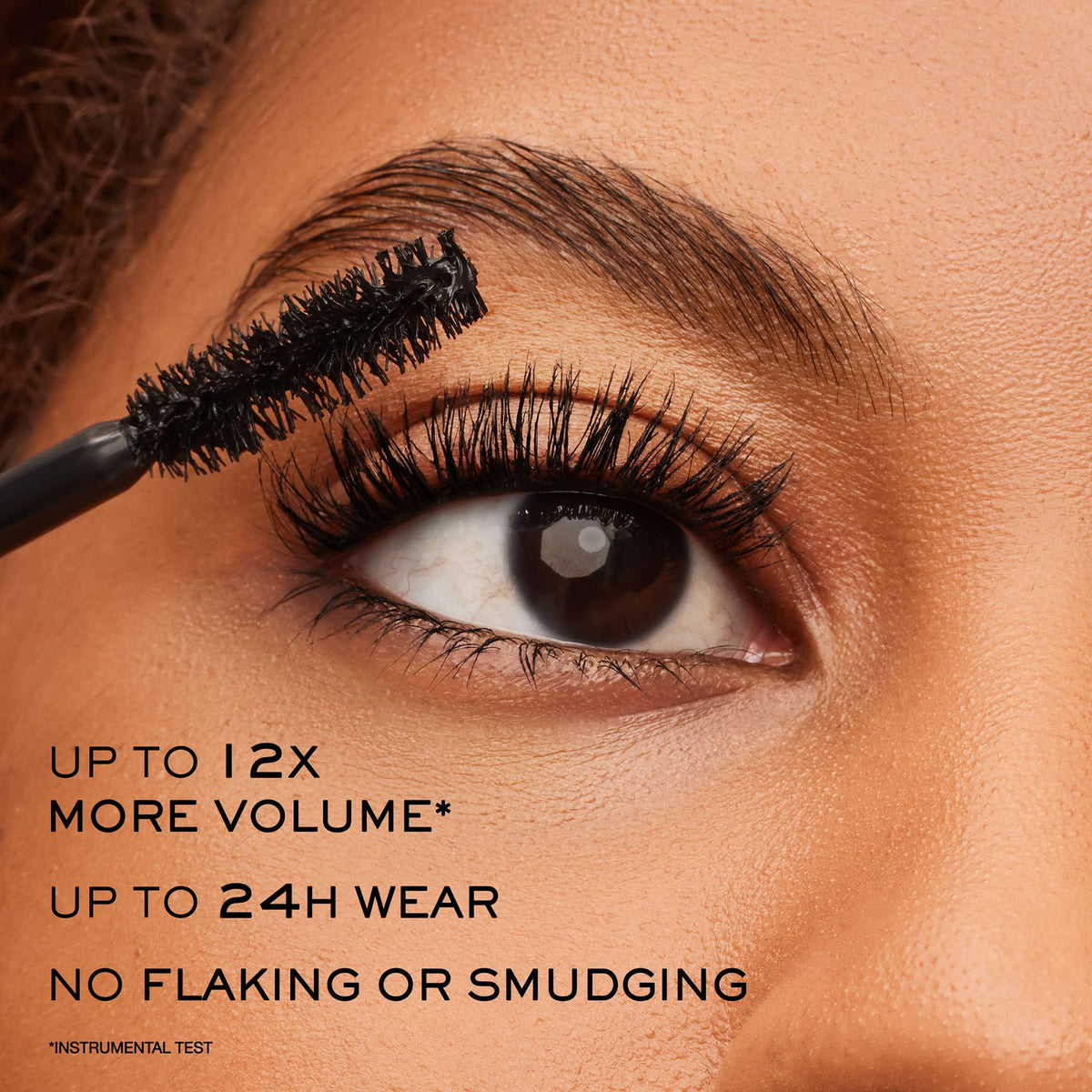 Lancôme tube beside coin for scale showing travel‑friendly size benefit