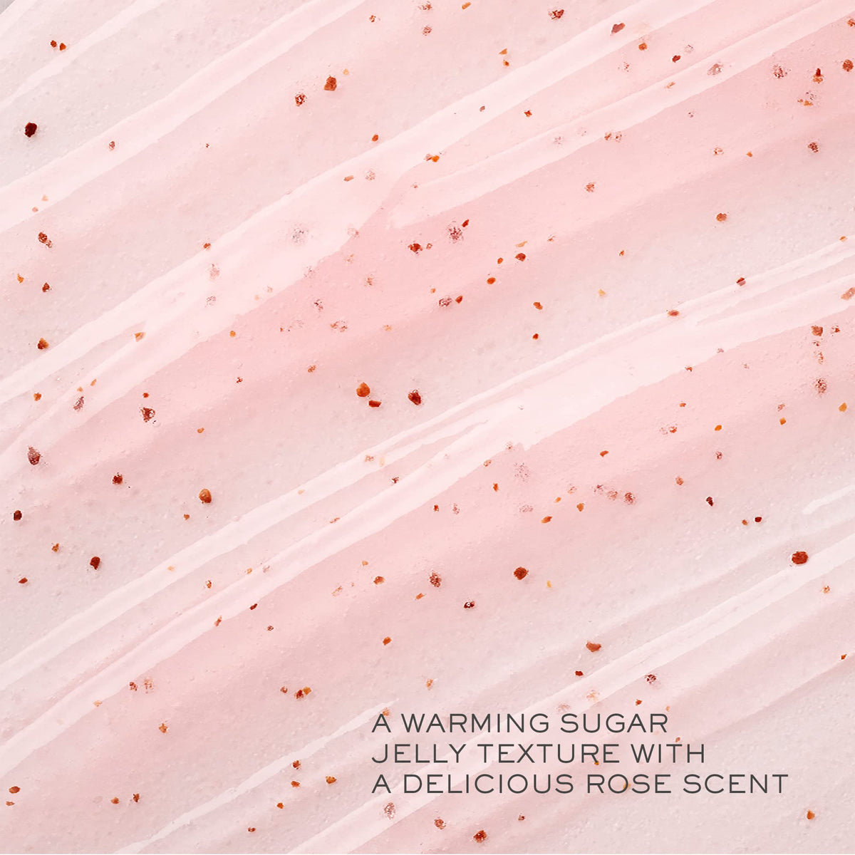 Lancôme close-up of sugar-grain scrub texture with rose petals, highlights gentle exfoliation benefits