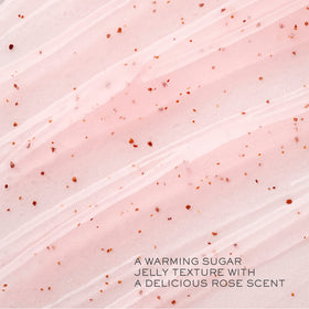 Lancôme close-up of sugar-grain scrub texture with rose petals, highlights gentle exfoliation benefits