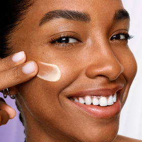 Lancôme serum held in hand showing compact 0.67 fl oz size and portability