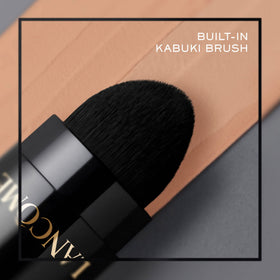 Lancôme foundation stick in handbag lifestyle scene, convenient touch-up solution benefit