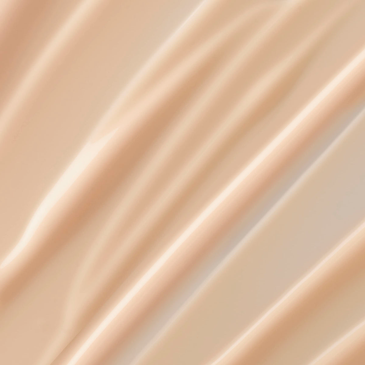 Lancôme Trésor lotion texture close-up demonstrating lightweight absorption and smooth finish
