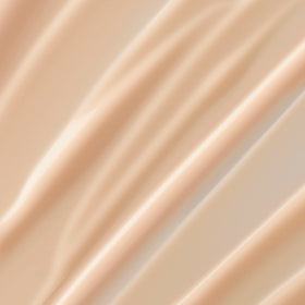 Lancôme Trésor lotion texture close-up demonstrating lightweight absorption and smooth finish