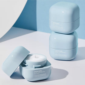 LANEIGE cream beside hand for scale demonstrating compact, travel-friendly size