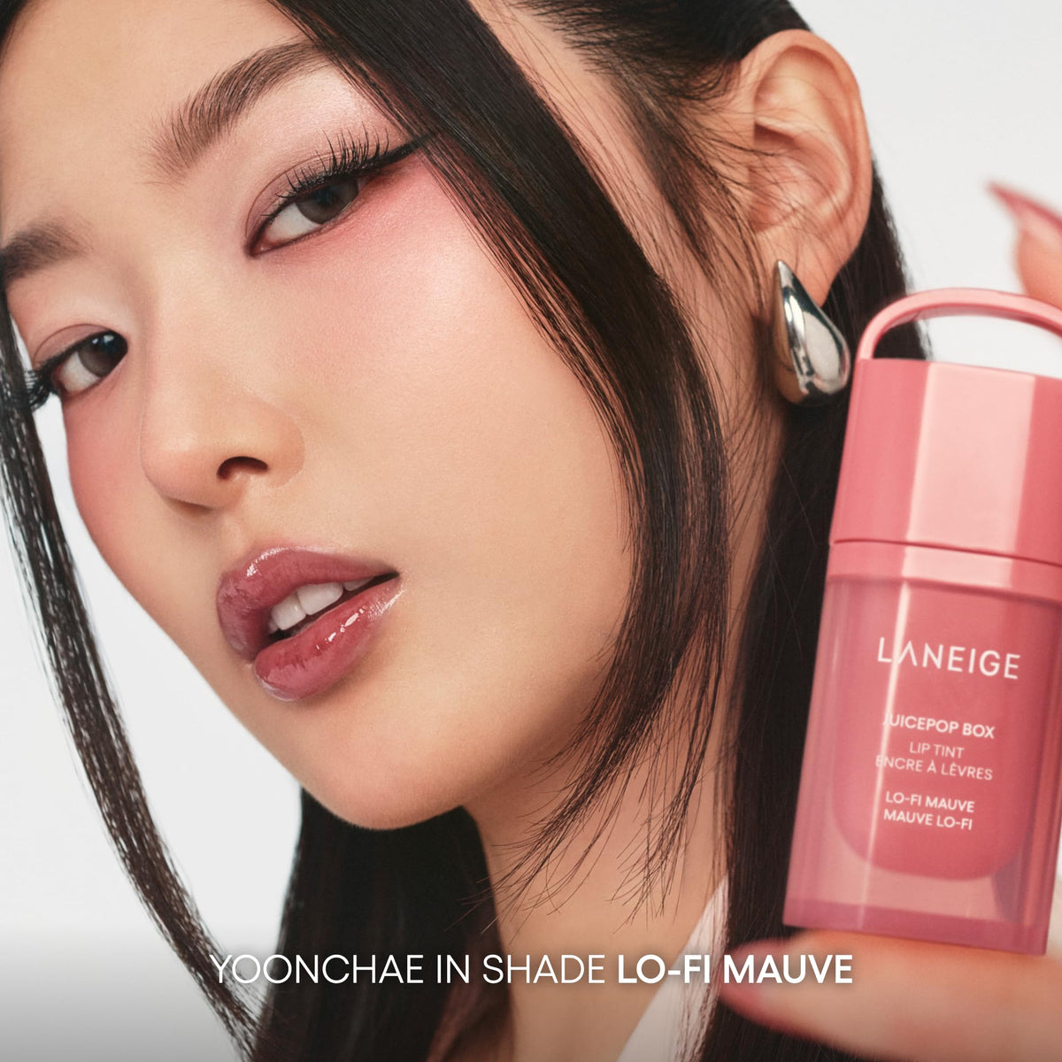 LANEIGE tucked in a purse with phone and keys highlighting portability