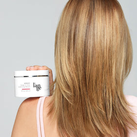 L'ANGE HAIR jar next to hand showing 10 oz size and scale benefit