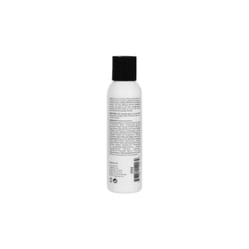 L'ANGE HAIR 4 fl oz bottle next to hairbrush showing size and portability