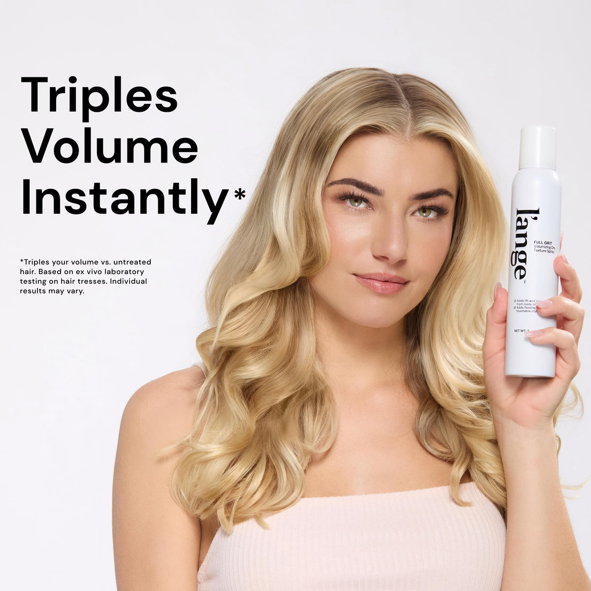 L'ANGE HAIR spray dispersing on dry hair to add instant lift and body