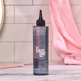 L'ANGE HAIR on bathroom vanity in lifestyle shot suggesting everyday use