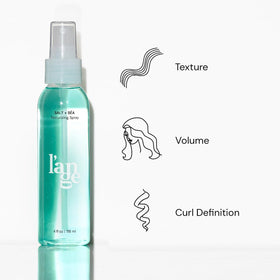 L'ANGE HAIR mist spraying from nozzle into hand showing easy, even application