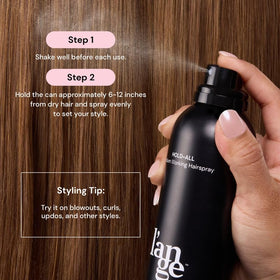 L'ANGE HAIR bottle in hand showing scale for travel-friendly styling convenience