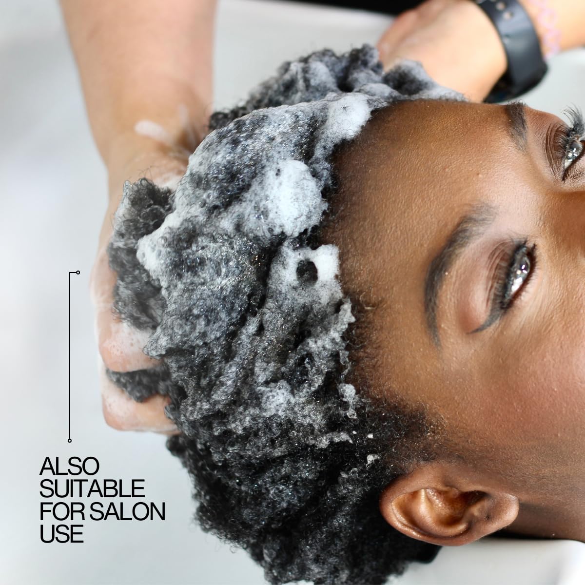 Lasio shampoo in hand during application showing easy rinsing benefit