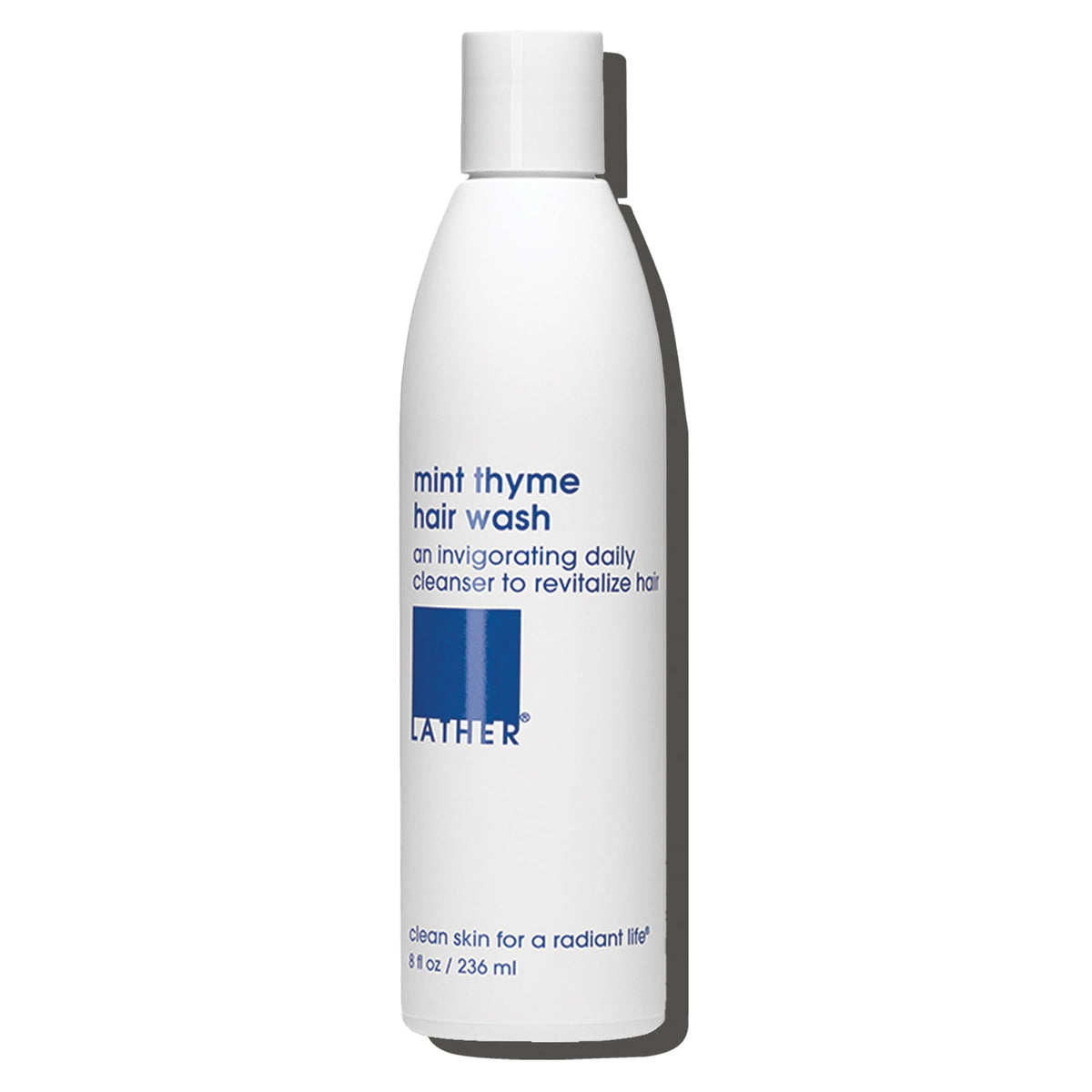 LATHER mint thyme hair wash front label showing product name and size, clear branding benefit