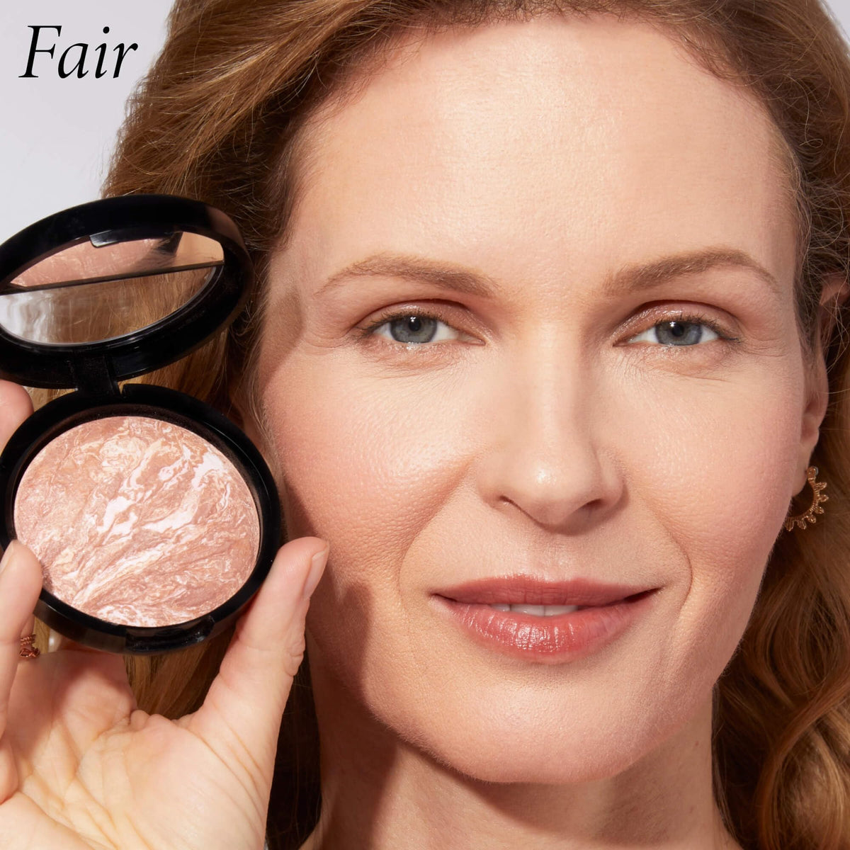 LAURA GELLER compact beside coin showing product size and portability