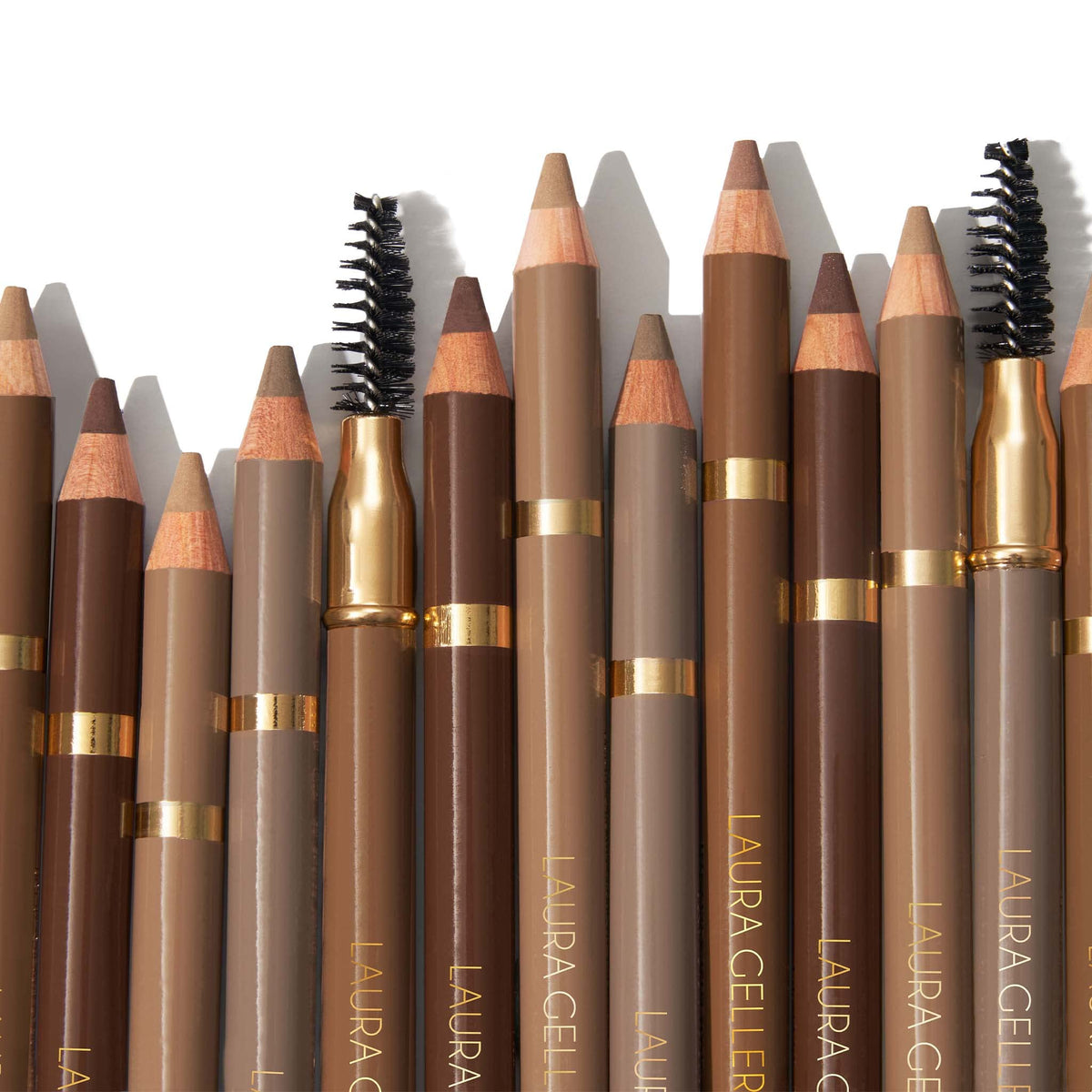LAURA GELLER NEW YORK pencil held in hand showing size and easy portability for touch-ups