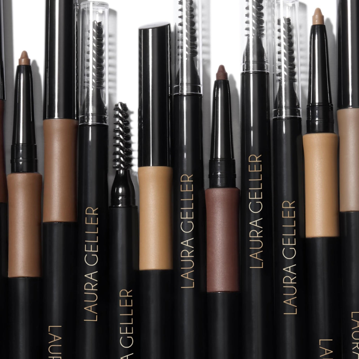 LAURA GELLER NEW YORK travel flatlay with pencil for on-the-go brow touch-ups
