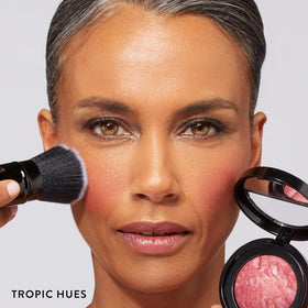 LAURA GELLER 3pc kit flatlay shows foundation, kabuki brush, and Tropic Hues blush