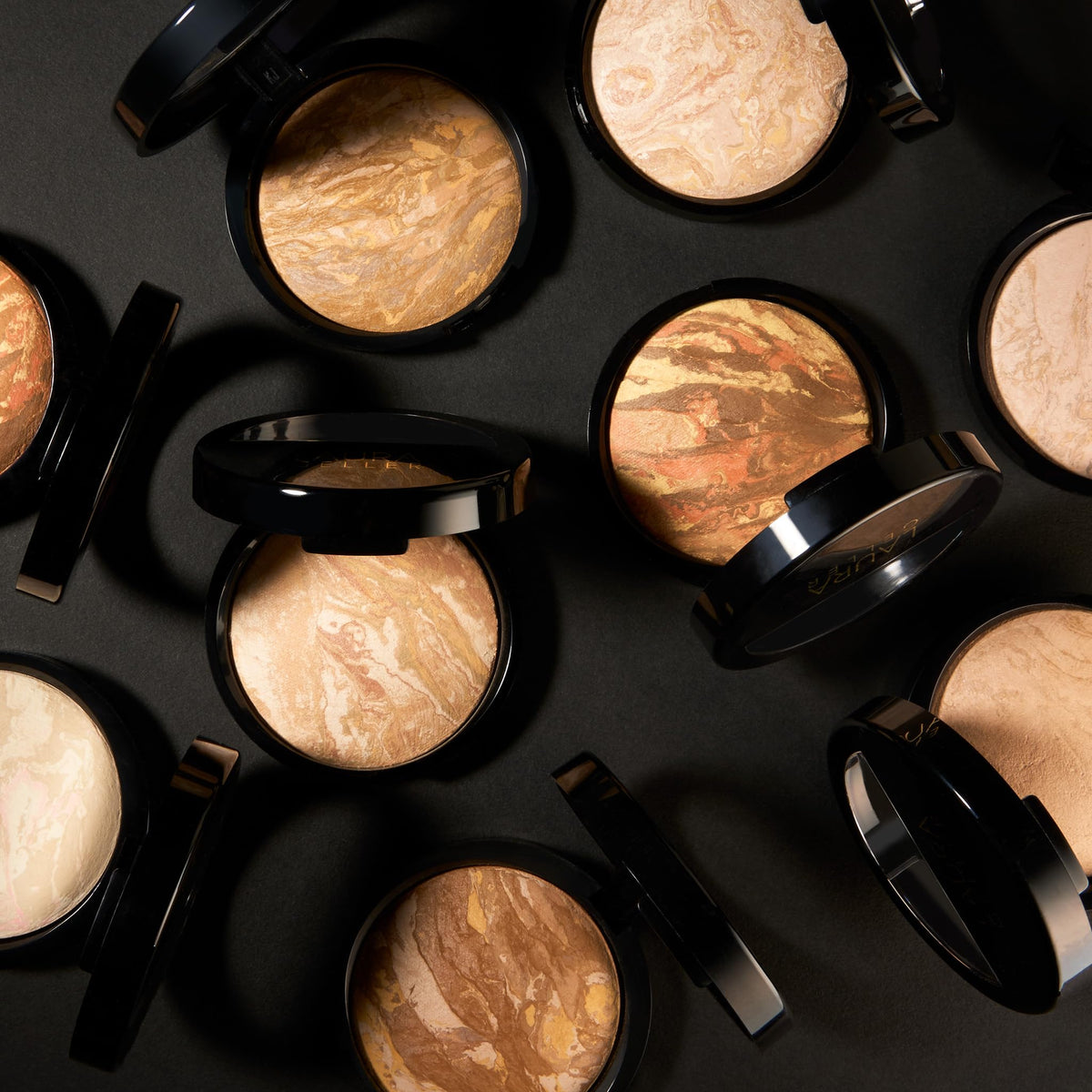 LAURA GELLER NEW YORK kit inside a handbag ready for on-the-go touch-ups