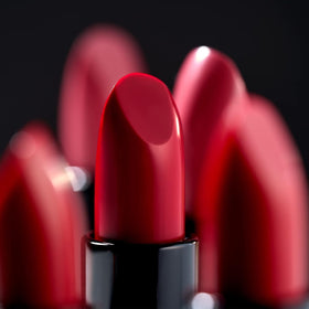 LAURA GELLER NEW YORK lipstick in fashion handbag showing portable size and on-the-go convenience