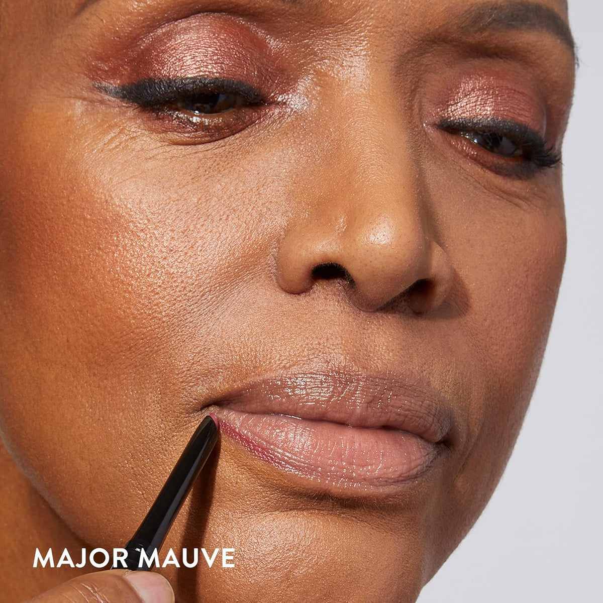 LAURA GELLER NEW YORK applying liner to lip edge for crisp definition