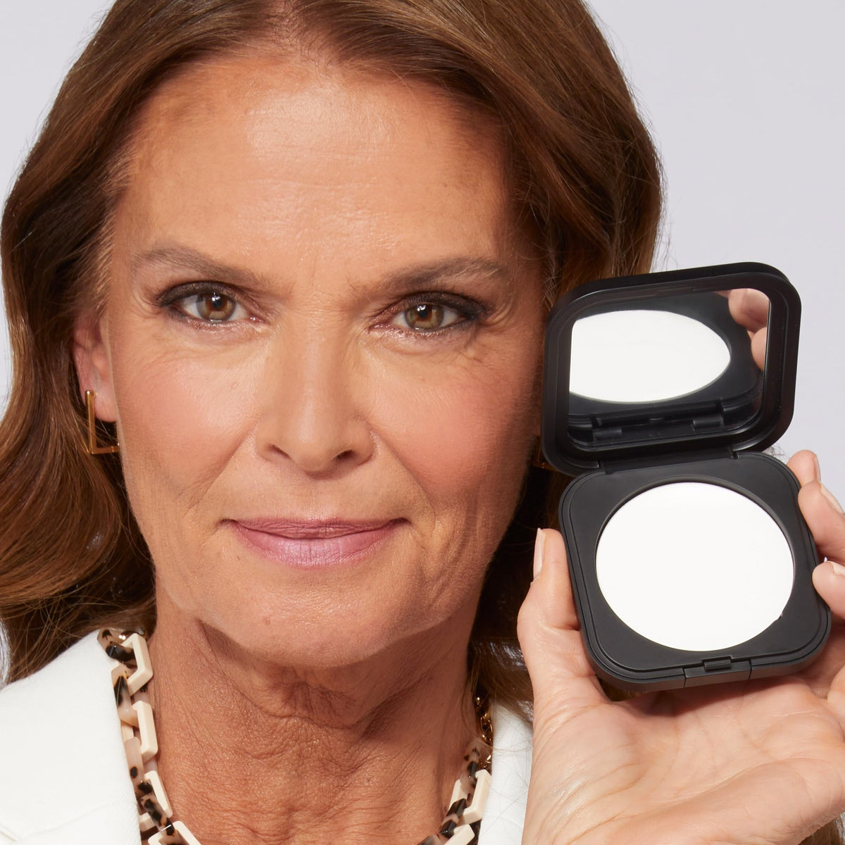 LAURA GELLER NEW YORK close-up texture of finely milled powder for blur and matte effect