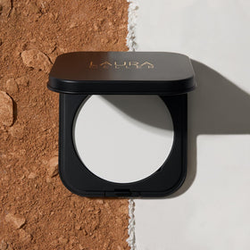 LAURA GELLER NEW YORK swatch on skin over foundation showing translucent no-cast finish