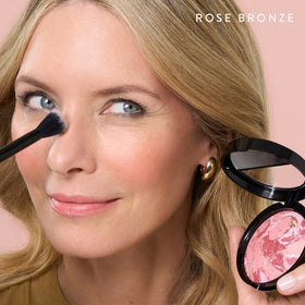 LAURA GELLER NEW YORK model applying product to cheeks for natural lift