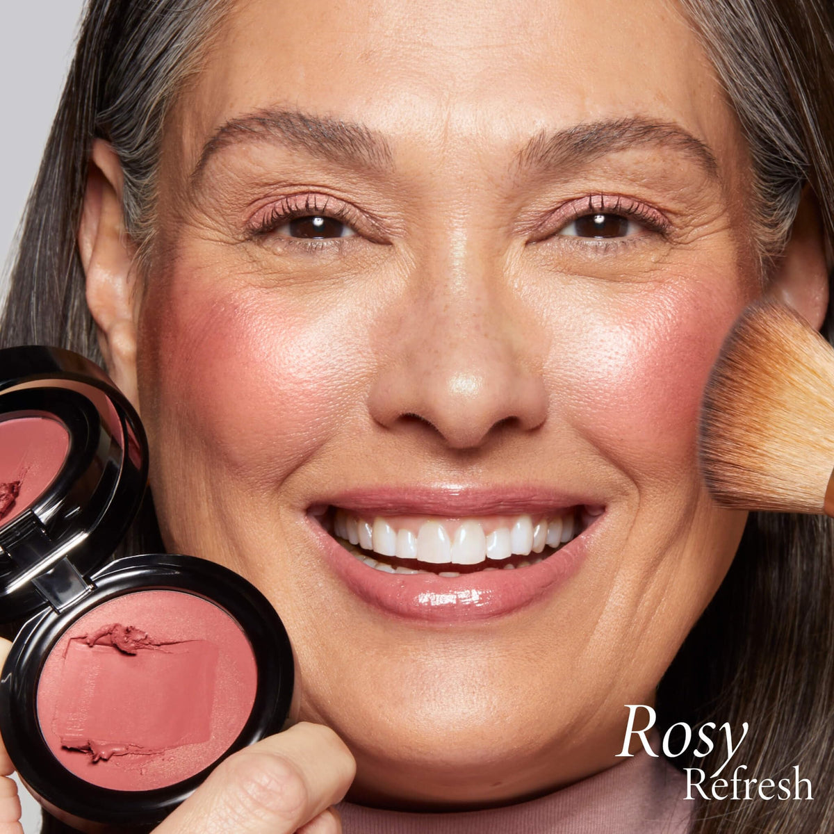 LAURA GELLER NEW YORK applying balm to lips for tinted moisturizing coverage
