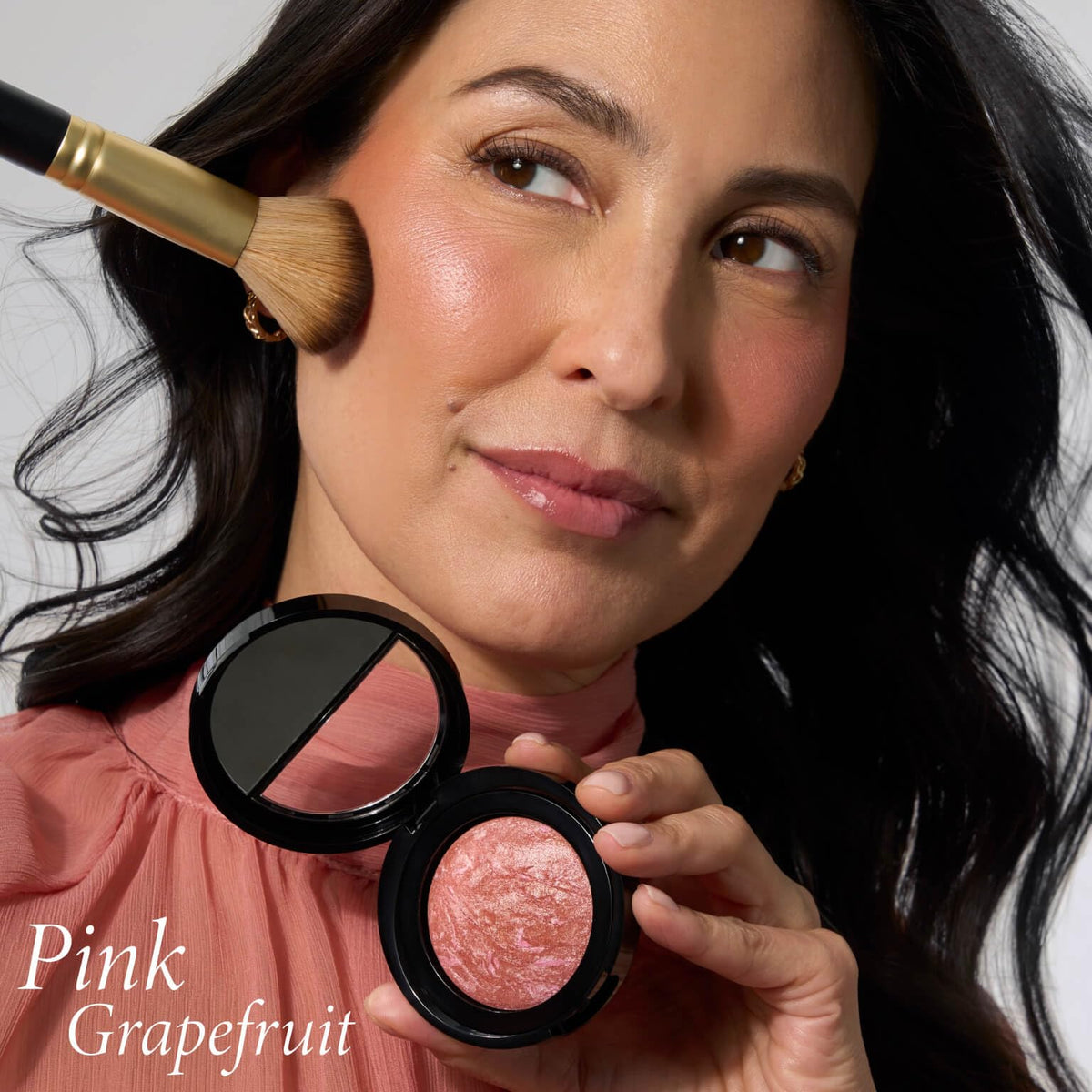 LAURA GELLER brush applying blush demonstrating easy, buildable application for lift