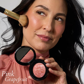 LAURA GELLER brush applying blush demonstrating easy, buildable application for lift