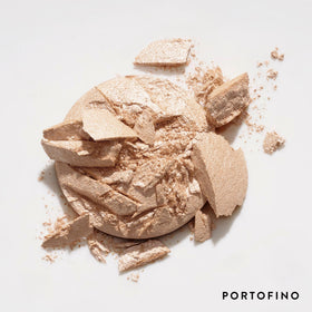 LAURA GELLER Portofino compact inside a purse conveying portability and on-the-go touchups