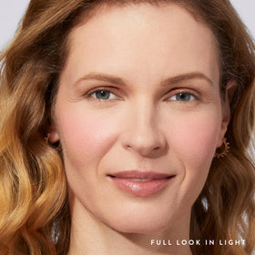 LAURA GELLER size comparison in hand highlights compact, travel-friendly kabuki brush