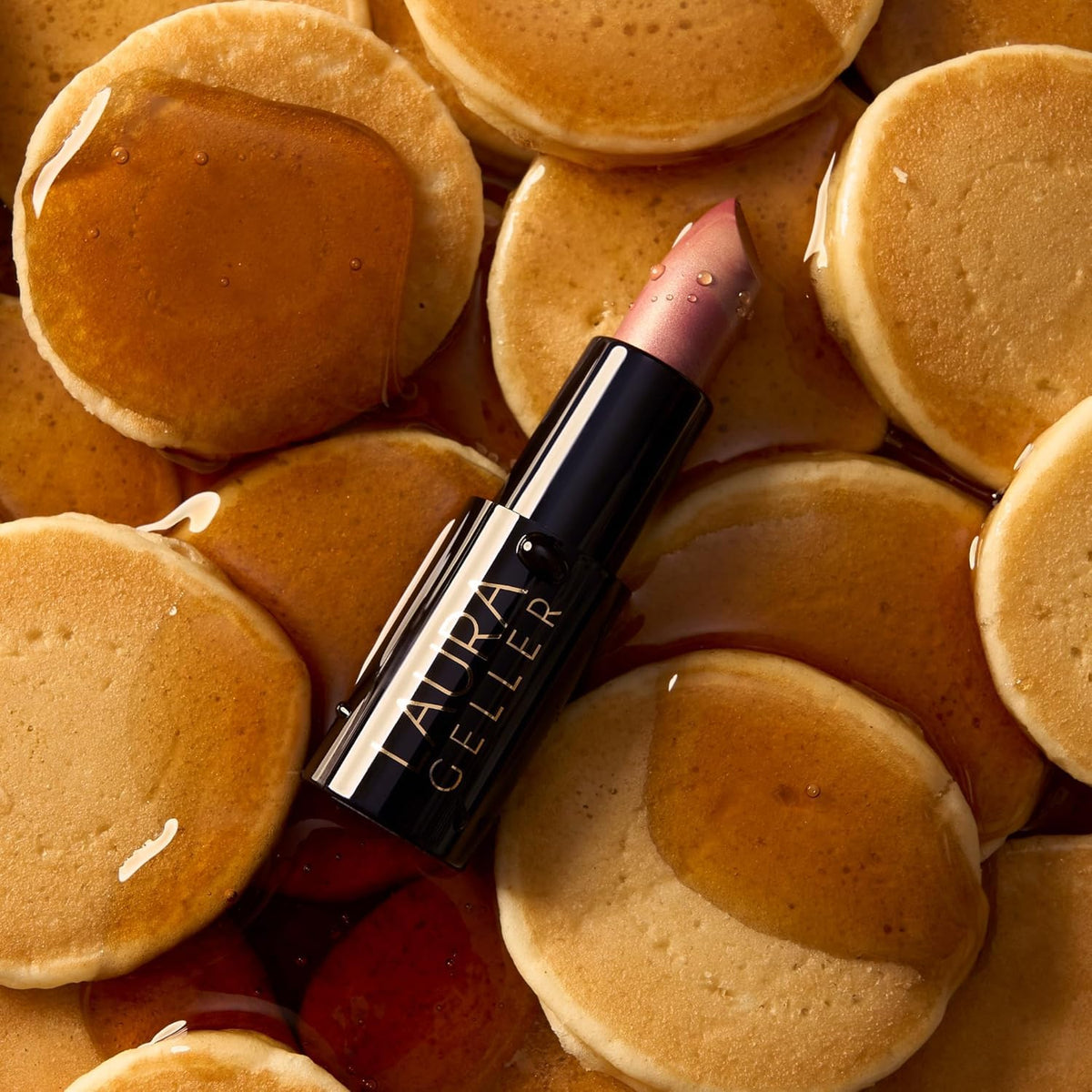 LAURA GELLER NEW YORK lipstick applied on lips highlighting natural sheen