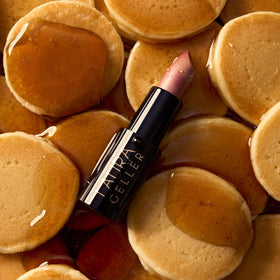 LAURA GELLER NEW YORK lipstick applied on lips highlighting natural sheen