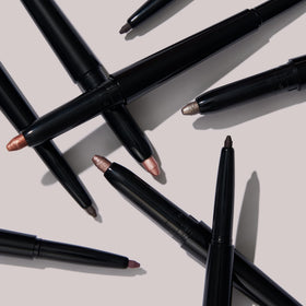 LAURA GELLER NEW YORK stick in hand to show compact travel-friendly size