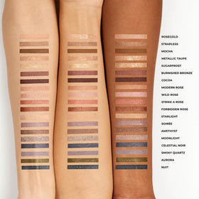 Laura Mercier mini stick in hand showing travel-friendly size and portability