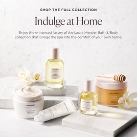 Laura Mercier cream on towel in bathroom lifestyle scene promoting daily self-care and comfort