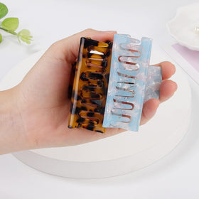 LAXIZAR clip held in hand to illustrate three-inch size and easy handling