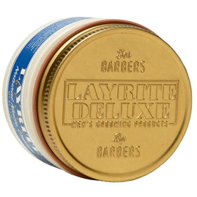 Applying Layrite cream to hands before styling for easy distribution and control