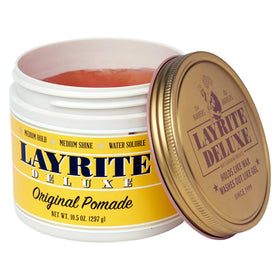 Layrite pomade texture closeup on fingers, smooth spreadability visible