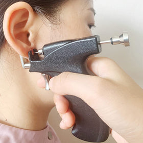LECIEL gun in use performing ear piercing illustrating controlled single-action application