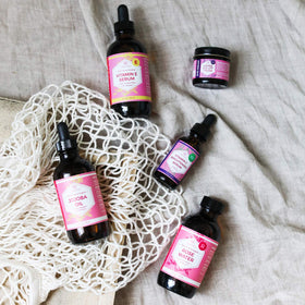 Leven Rose bottle in hand showing 4 oz scale for portability
