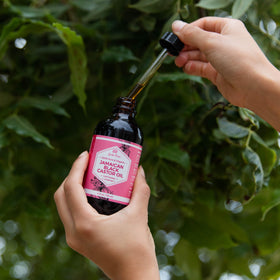Leven Rose 4 oz bottle in hand for scale and portability benefit