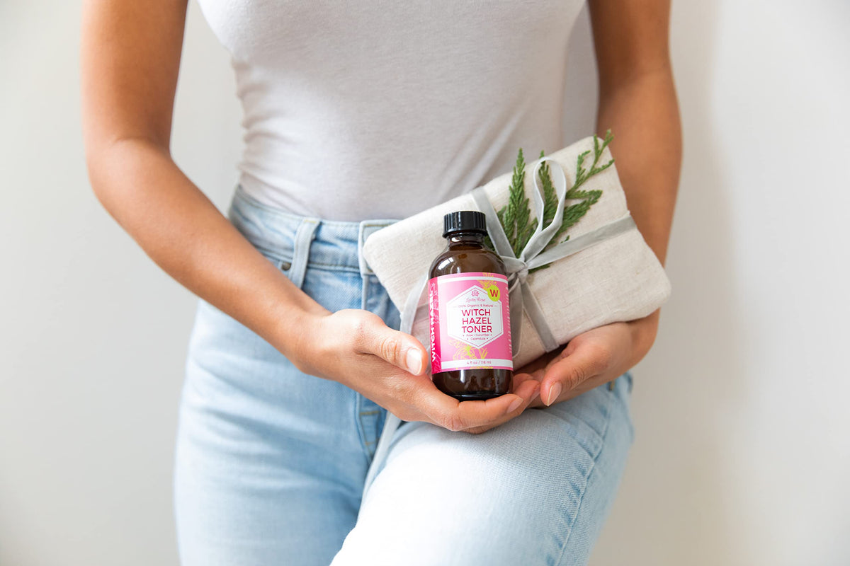 Leven Rose 4 oz bottle held in hand to show true size and portability
