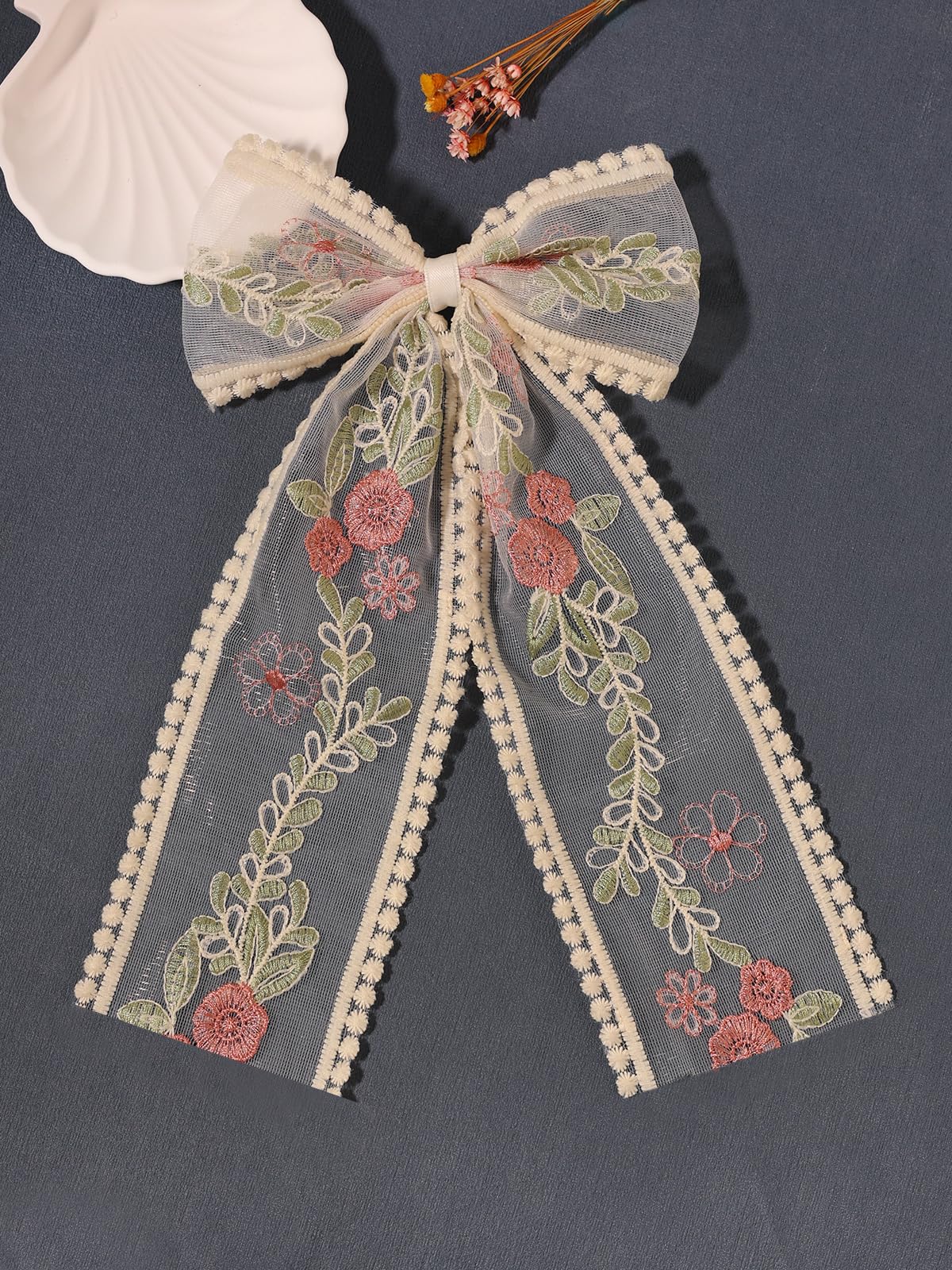 LFOUVRE bow beside a coin showing size and scale for accurate fit