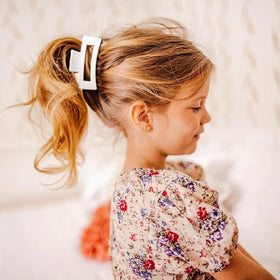 LILIEBE holding a messy bun while cooking to keep hair tidy