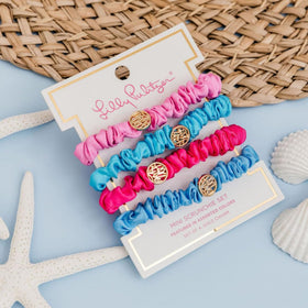 Lilly Pulitzer scrunchie held in hand to show compact size and stretch benefit