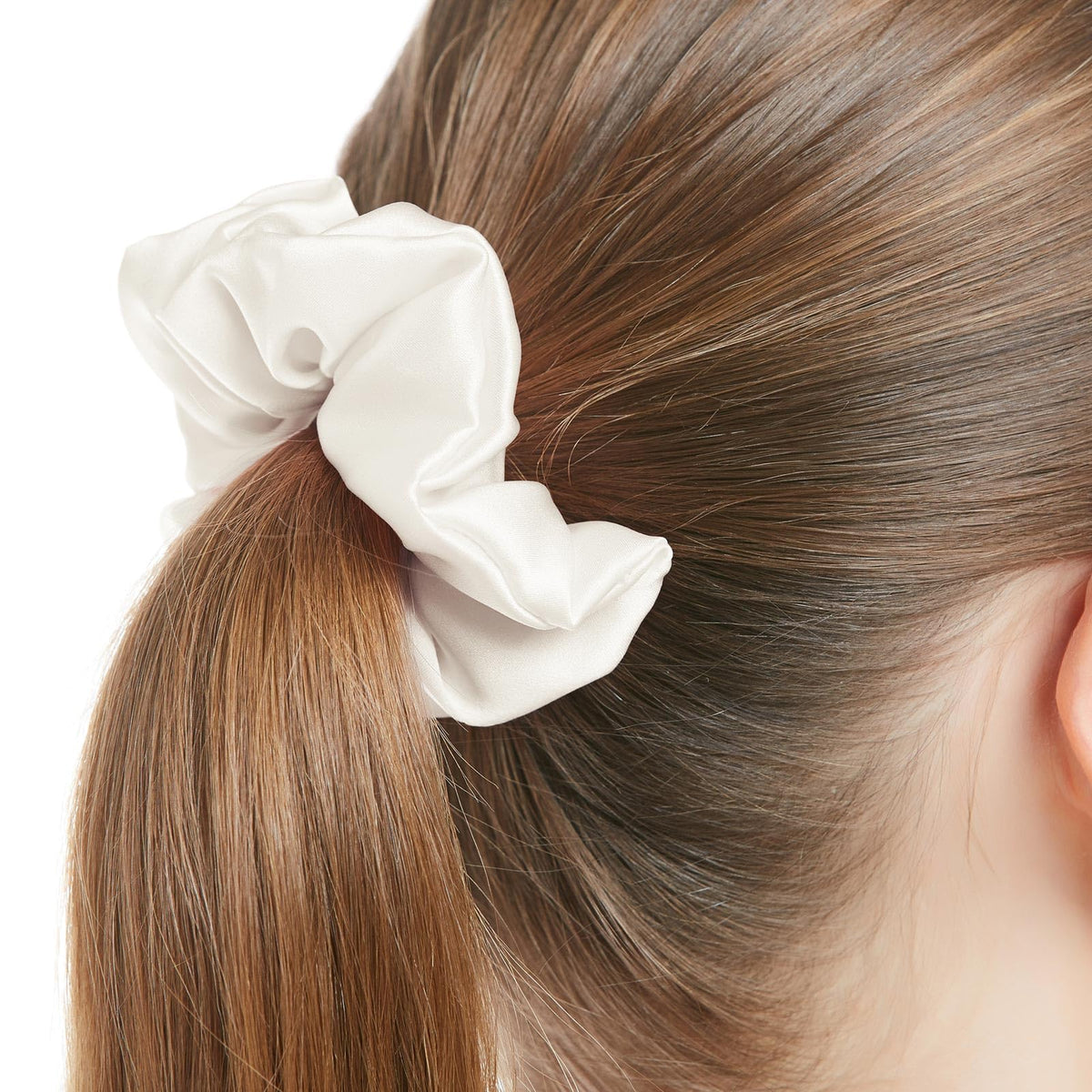 LilySilk scrunchie holding a ponytail, preventing frizz and minimizing breakage