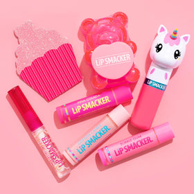 Child holding Lip Smacker Princess Glam Bag smiling, fun safe cosmetics for kids